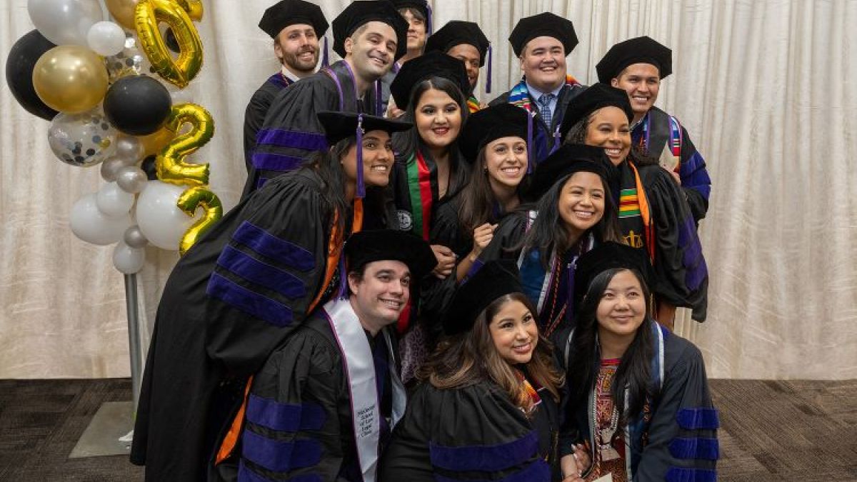 group of students posing for a photo in graduation attire